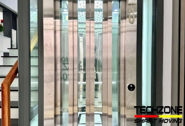 Thang Máy Kính Giá Bao Nhiêu: Bóc Tách Các Yếu Tố Cấu Thành Và Vì Sao "Tủ Điều Khiển Châu Âu" Lại Đắt Giá